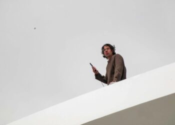 Activist scales DC bridge in protest of Trump’s ‘colossal failure’ Iran war