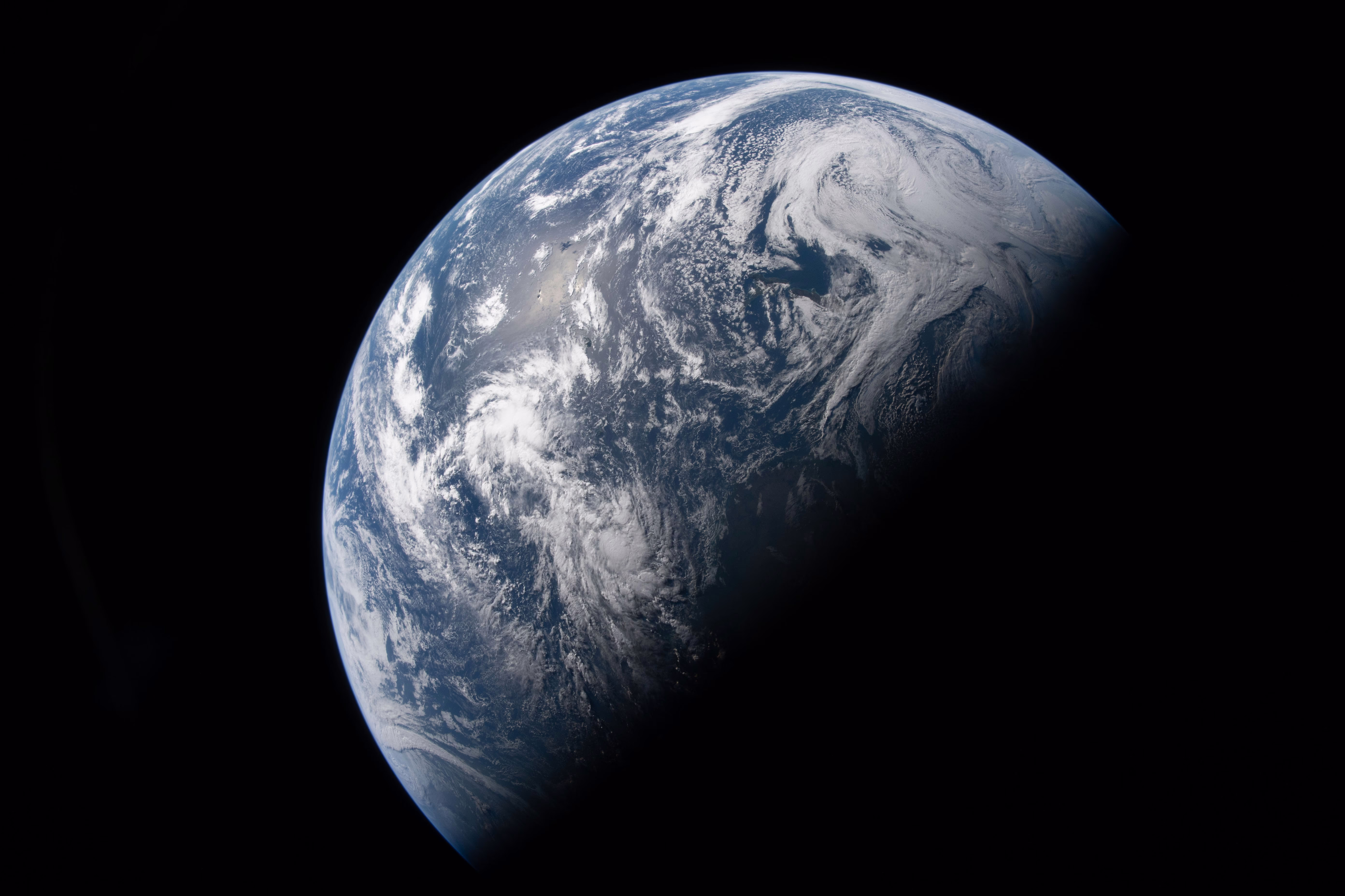A view of the Earth, half-illuminated, seen from spce