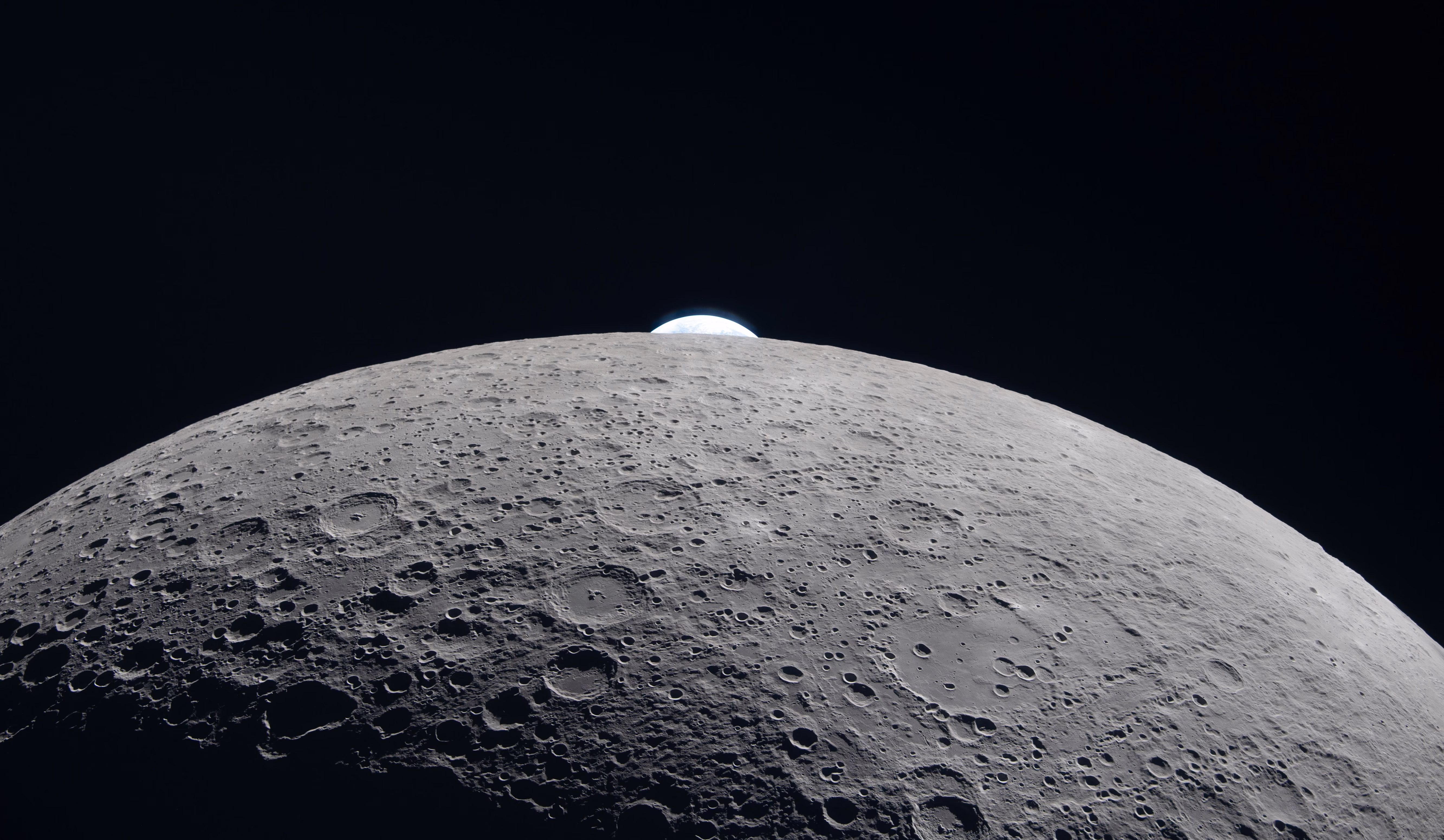 The Earth passes out of view, behind the moon.