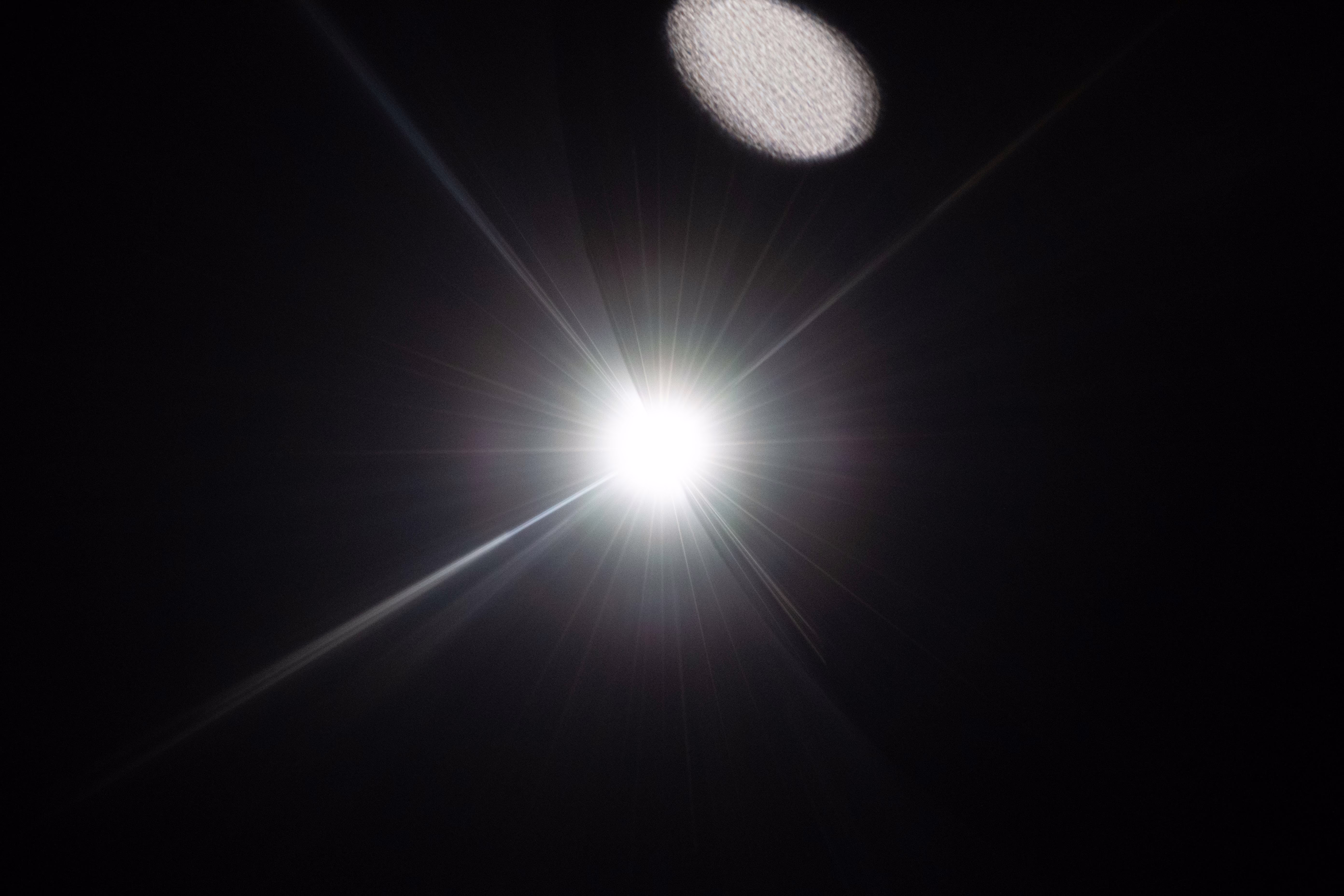 A bright flare of sunlight, seen along the edge of the dark moon.