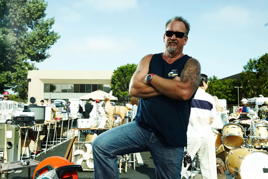 Darrell Sheets in season 2 of Storage Wars, standing with arms crossed at an outdoor sale.