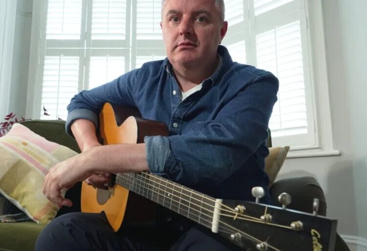 AI is splitting the music world. This 49-year-old guitarist used it to keep playing after Parkinson’s