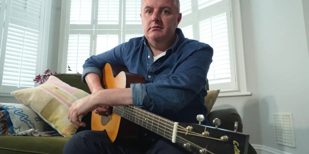 AI is splitting the music world. This 49-year-old guitarist used it to keep playing after Parkinson’s