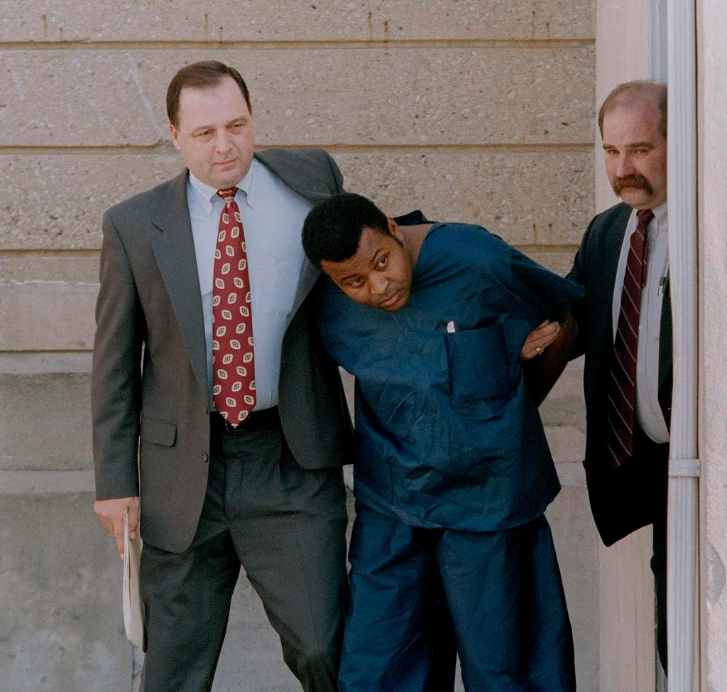 Colin Ferguson is led by detectives.