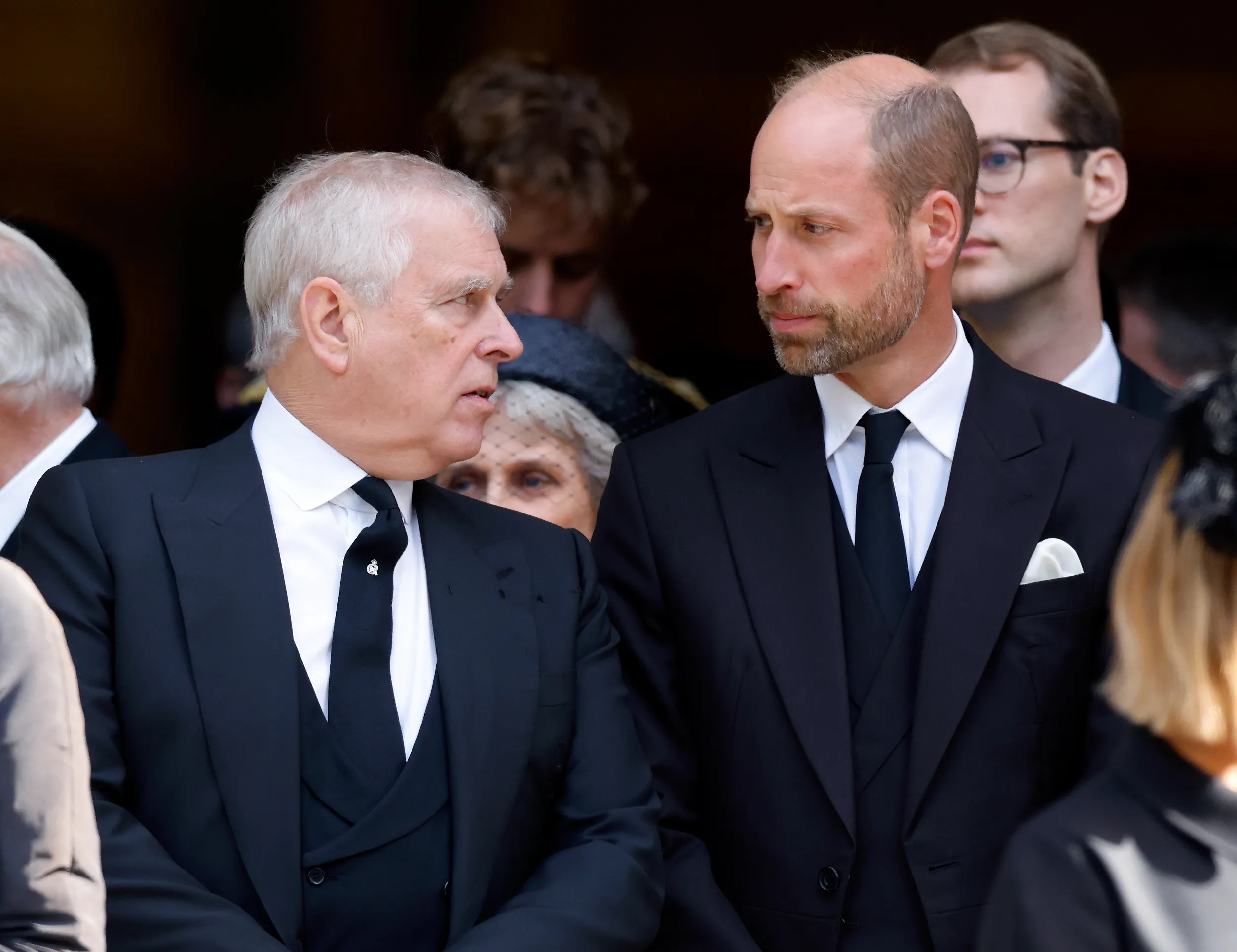 Prince Andrew and Prince William at a funeral.