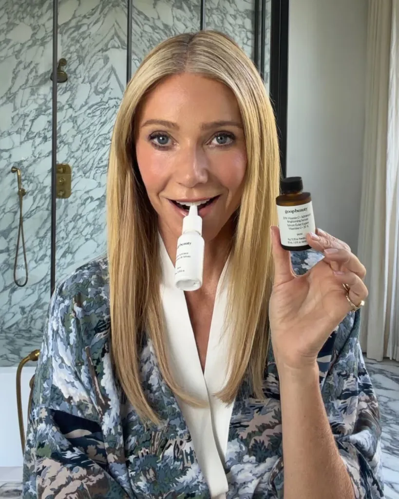 Gwyneth Paltrow holding two Goop Beauty products.