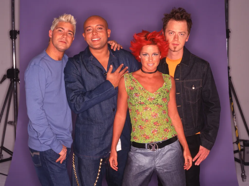 Portrait of Danish pop group Aqua, featuring Soren Rasted, Rene Dif, Lene Nystrom, and Claus Norreen.