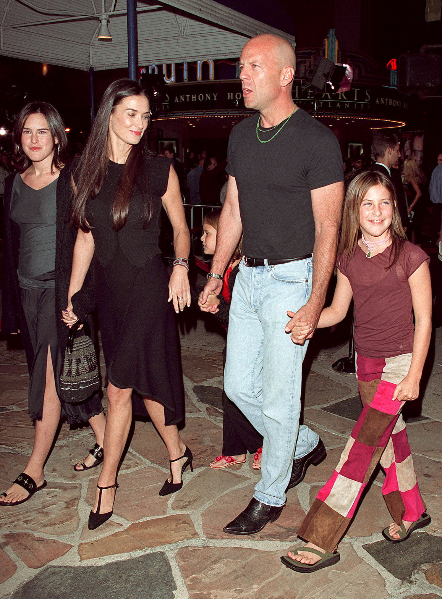 Bruce Willis and Demi Moore with their daughters Scout and Tallulah, holding hands at the 