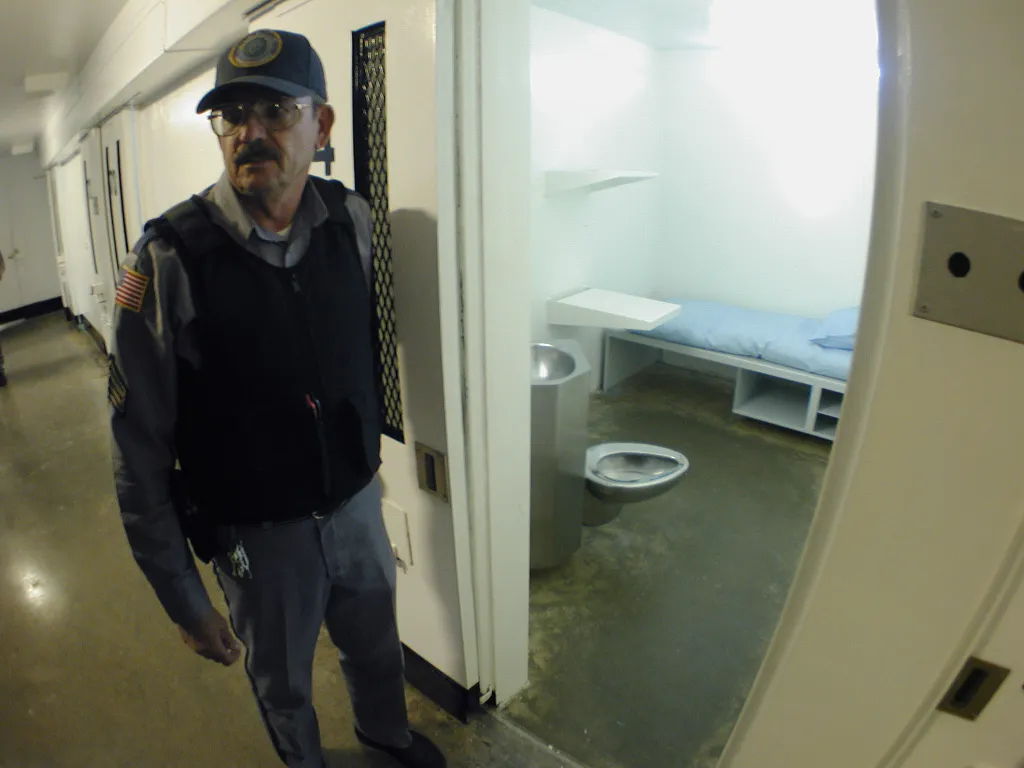 Death Row guard Sgt. James Ludwig stands outside a prison cell in Texas' Polunsky Unit.