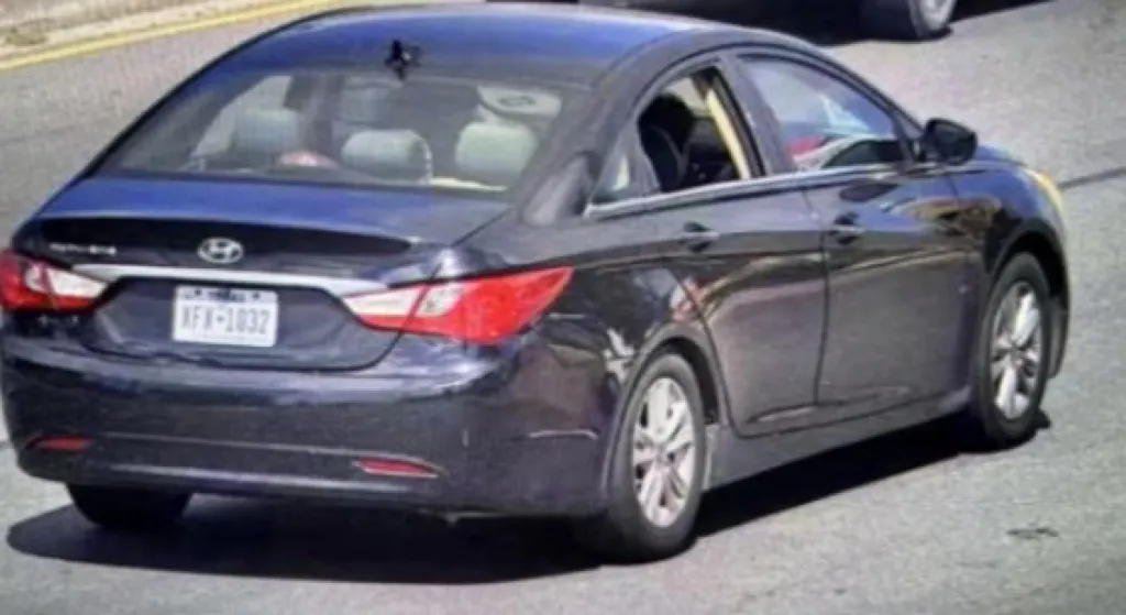 A black 2012 Hyundai Sonata with the back seat window shot out, displaying license plate XFX-1032.