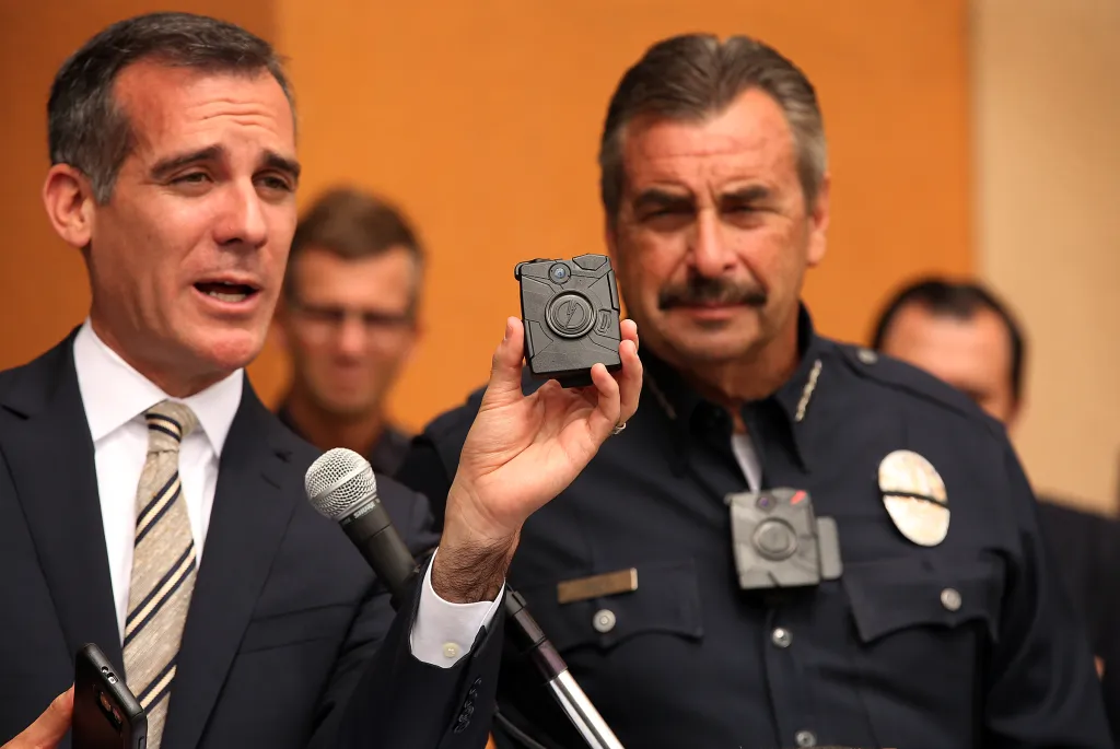 Mayor Garcetti and LAPD Chief Charlie Beck demonstrate the new LAPD body camera and cell phone.
