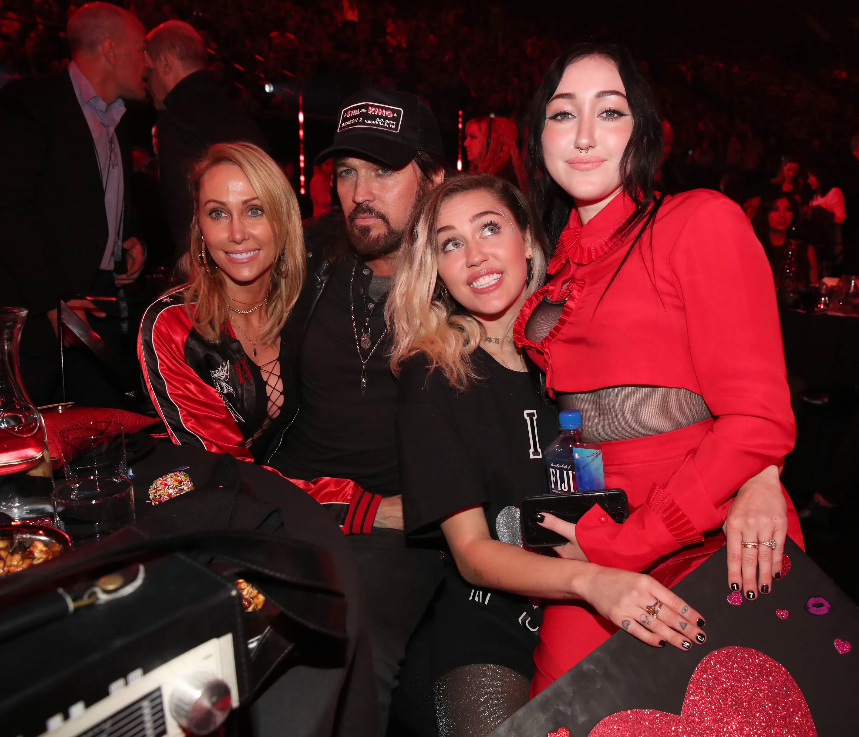 Tish Cyrus, Billy Ray Cyrus, Miley Cyrus, and Noah Cyrus pose together during the iHeartRadio Music Awards.
