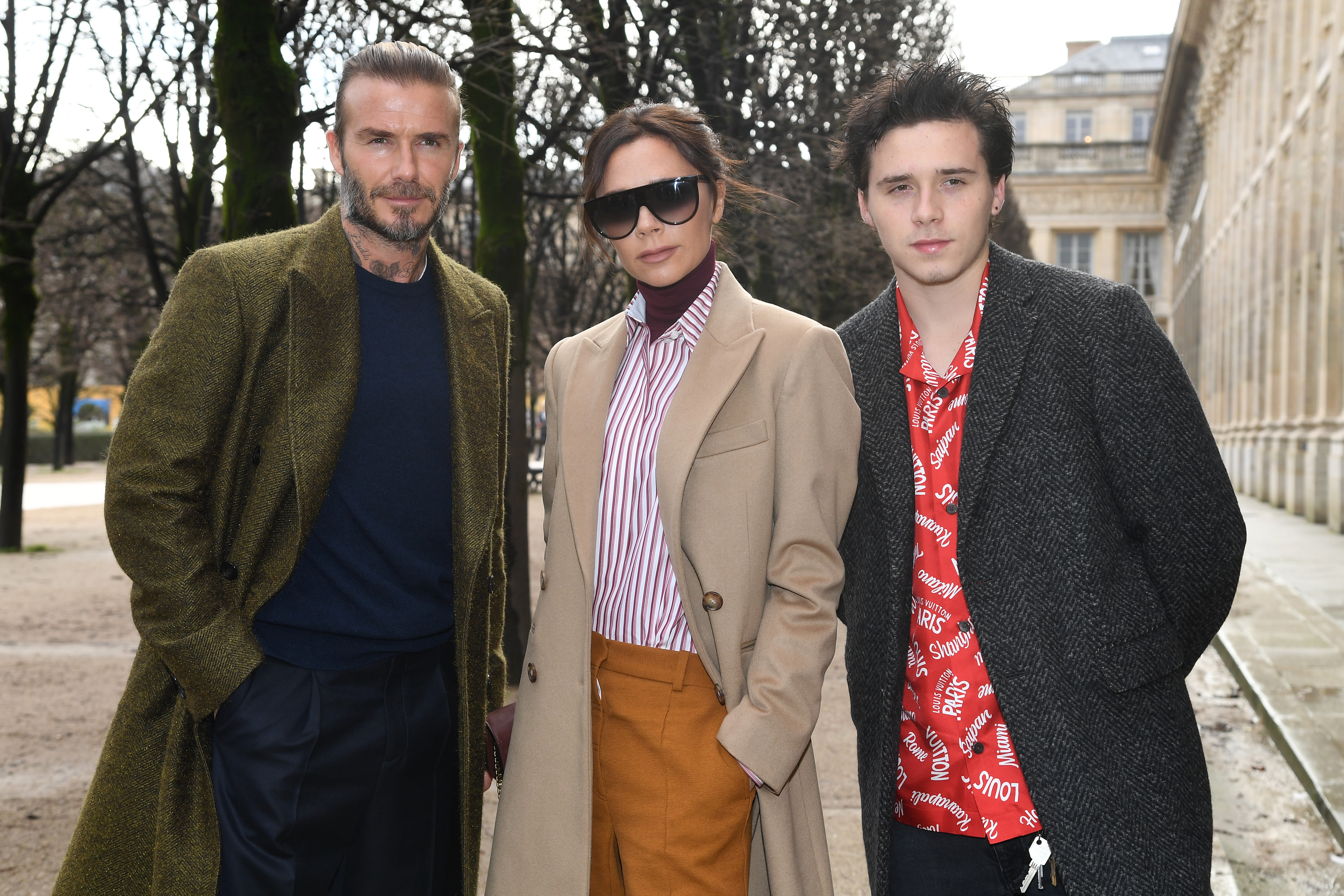 David Beckham, Victoria Beckham, and Brooklyn Beckham attend the Louis Vuitton Menswear Fall/Winter 2018-2019 show.