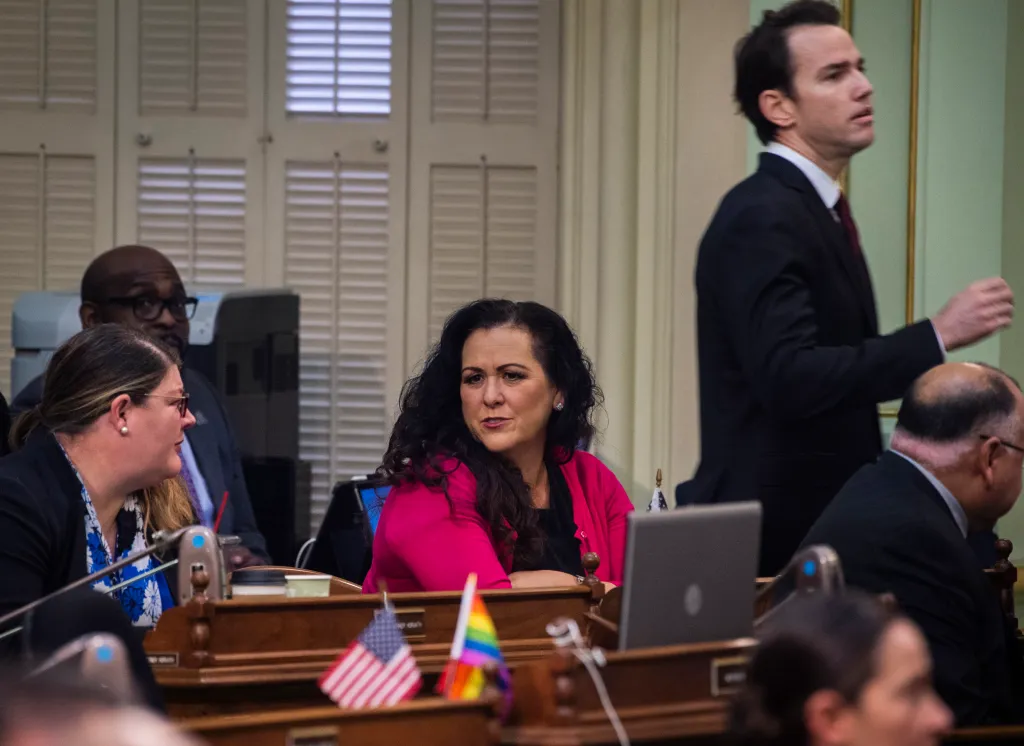 Assemblywoman Lorena Gonzalez talking with other assembly members on the Assembly floor.