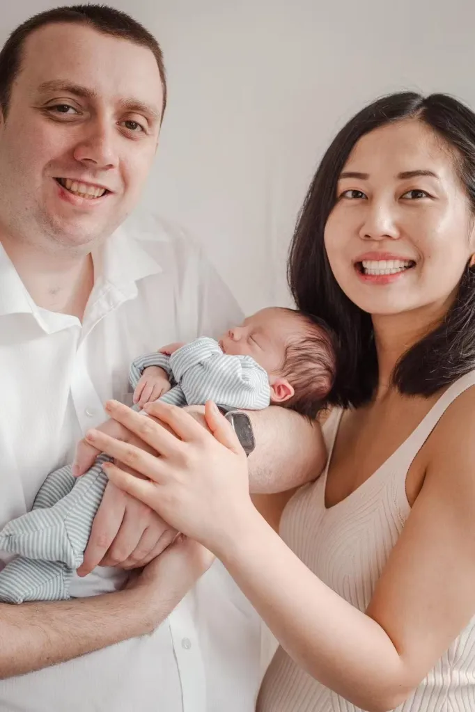 Leanne Zhang and Ben Donohoe with their sleeping baby.