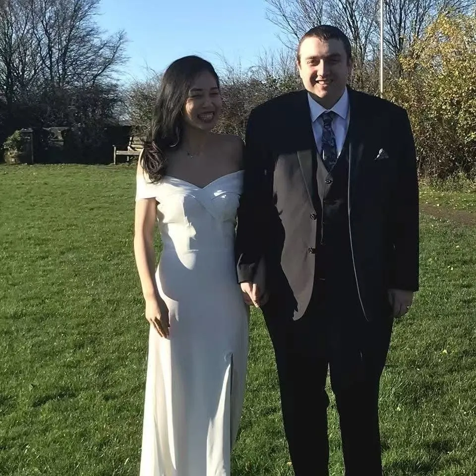 Leanne Zhang and Ben Donohoe holding hands on their wedding day.
