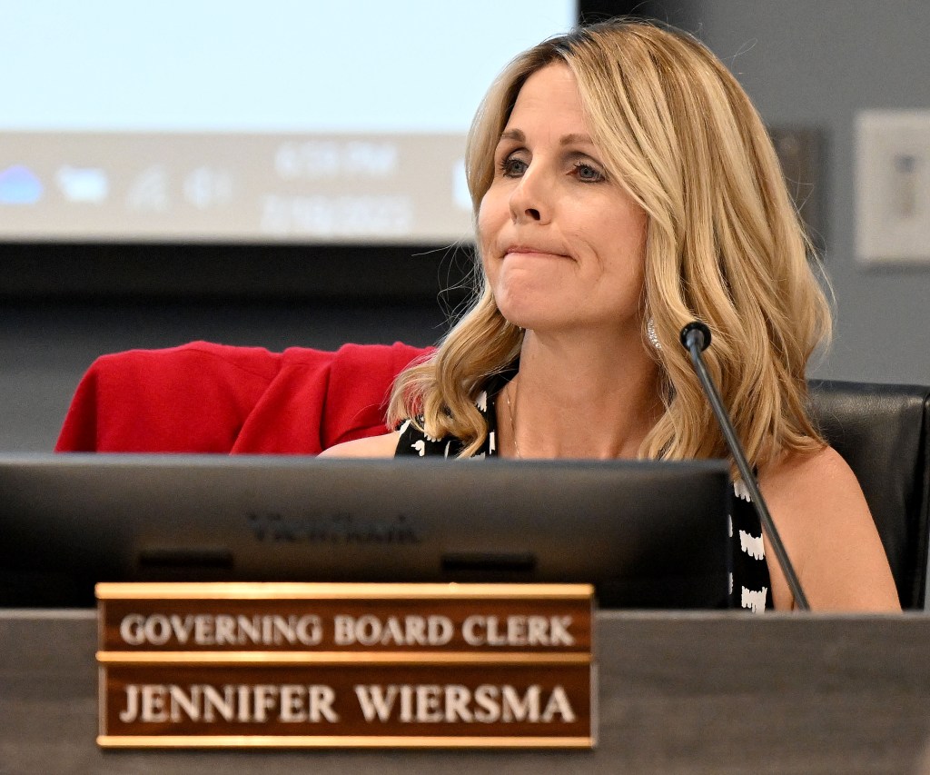 Governing Board Clerk Jennifer Wiersma listening to a speaker during a public board meeting.