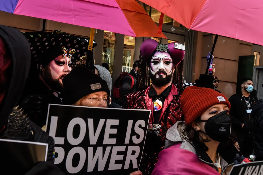 Protesters with signs, including one that reads 