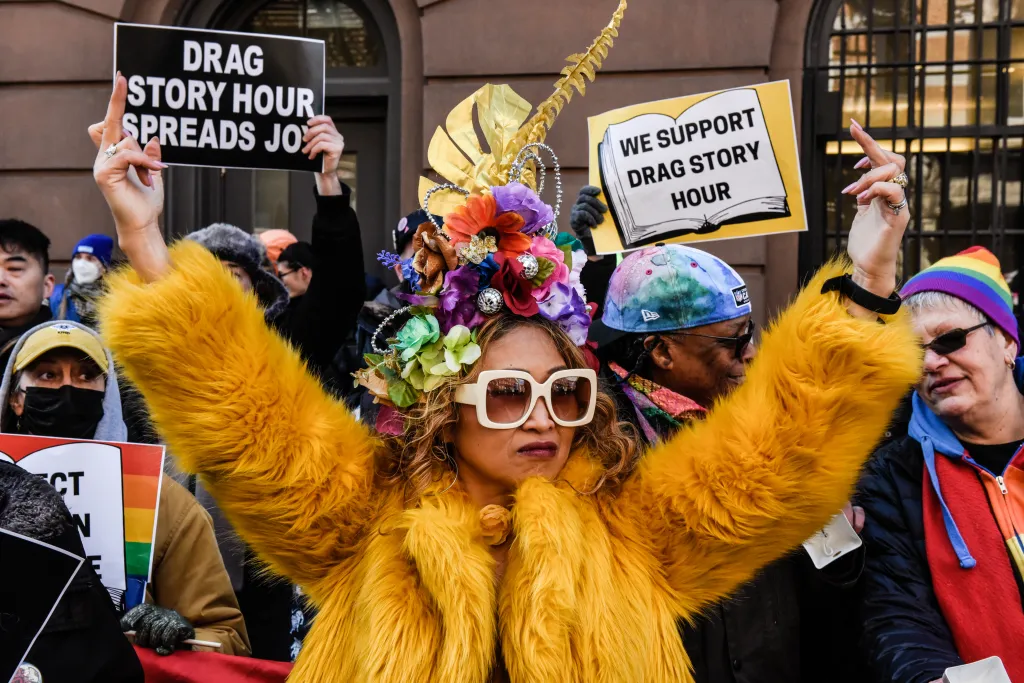 Protesters supporting Drag Queen Story Hour hold signs outside The Center in New York City.