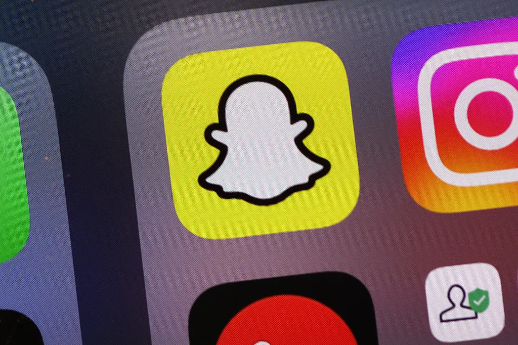 Illustration of the Snapchat app icon on a smartphone screen.