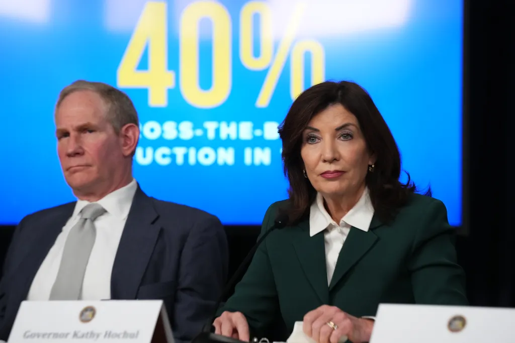 New York Governor Kathy Hochul and MTA CEO Janno Lieber at a news conference about congestion pricing, with a 