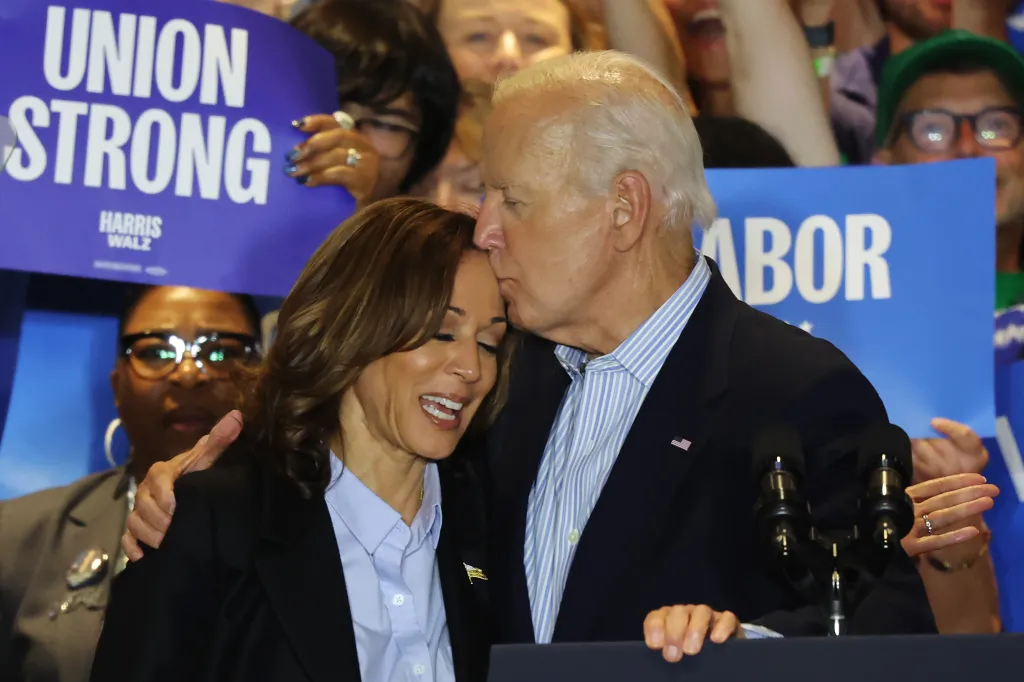 President Joe Biden kisses Vice President Kamala Harris on the forehead at a campaign event.