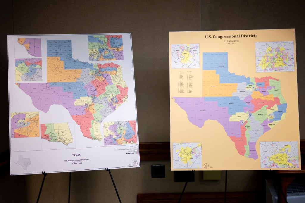 Two large maps of Texas congressional districts for 2025-2026 on easels at a redistricting committee meeting.