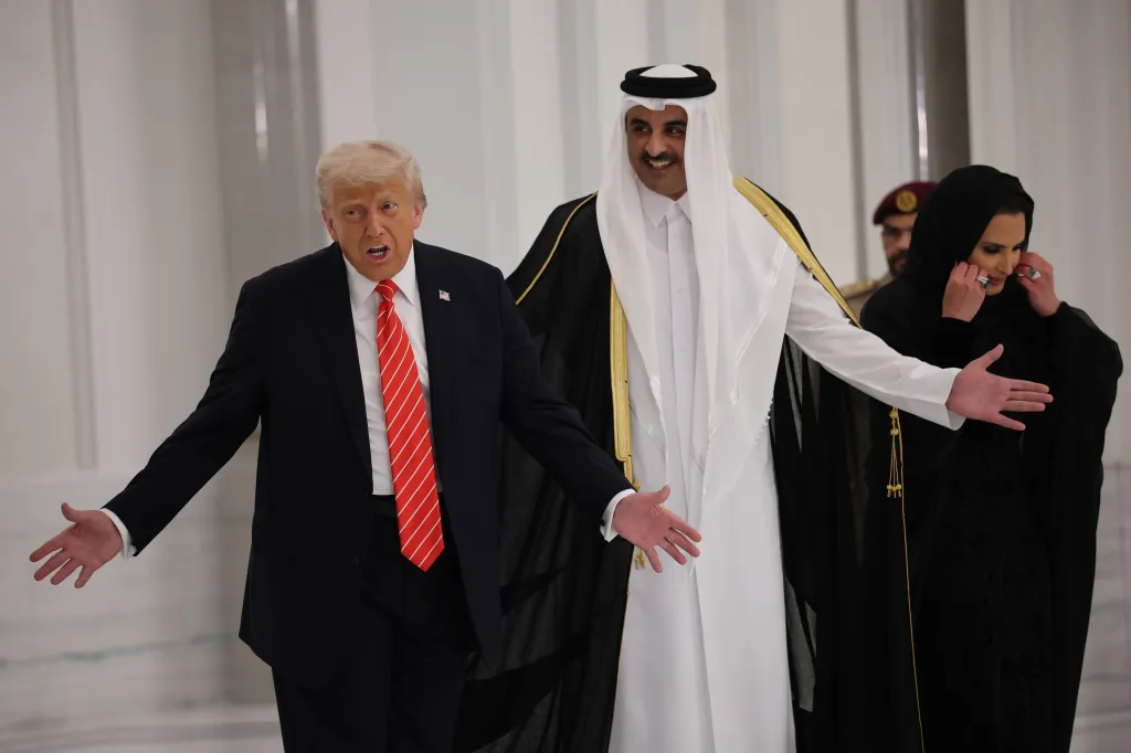 U.S. President Donald Trump and Emir of Qatar Tamim bin Hamad al Thani with a woman in a head covering, at a state dinner.