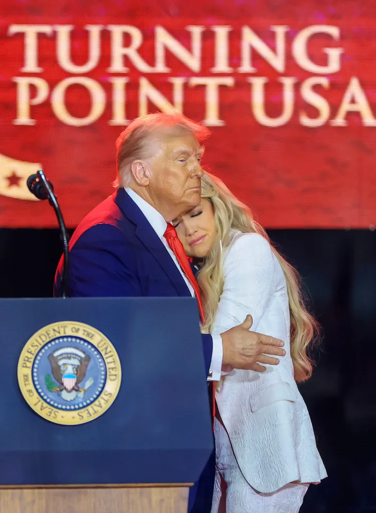 Erika Kirk embracing Donald Trump on stage at State Farm Stadium.