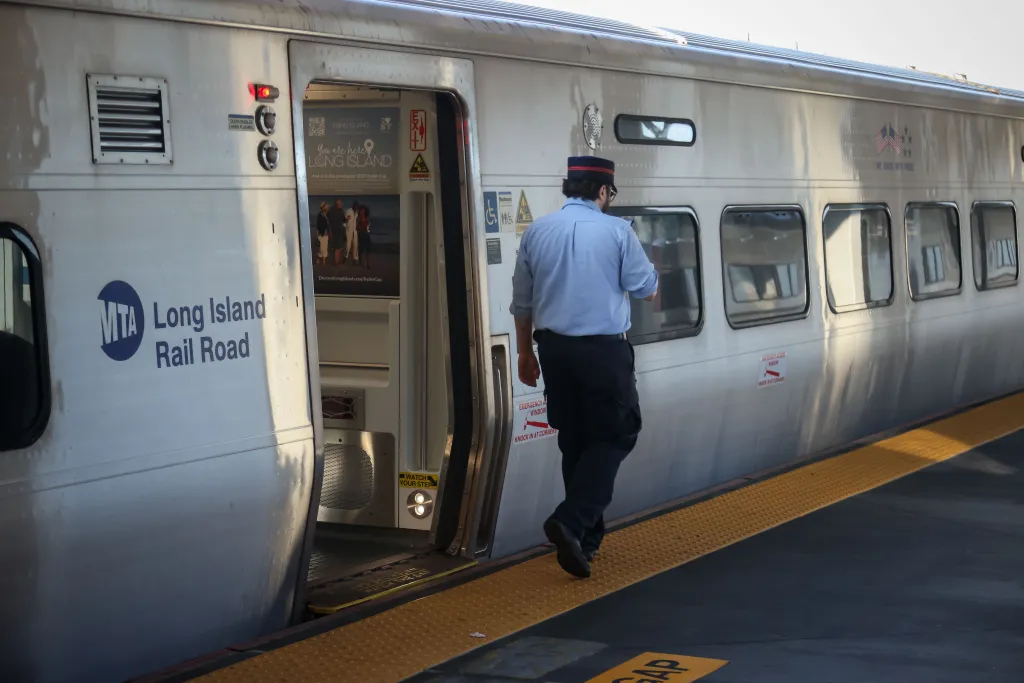 An LIRR employee on a train platform.