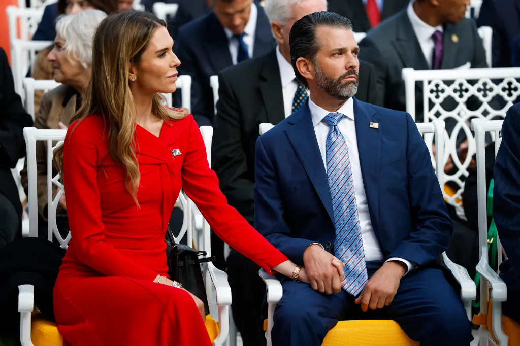 Donald Trump Jr. and Bettina Anderson hold hands while attending a Presidential Medal of Freedom ceremony.