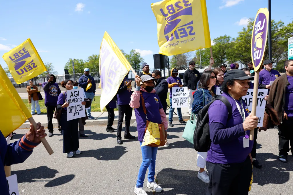 Members of the 32BJ Service Employees International Union (SEIU) protest at John F. Kennedy International Airport in Queens