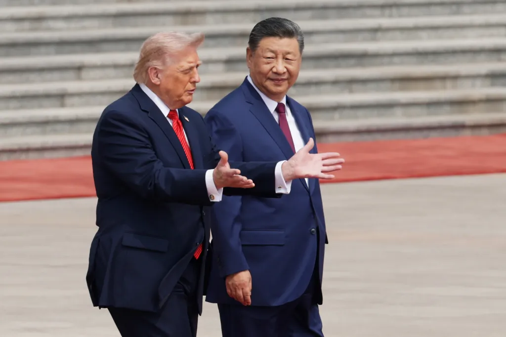 U.S. President Donald Trump and Chinese President Xi Jinping walk side-by-side.