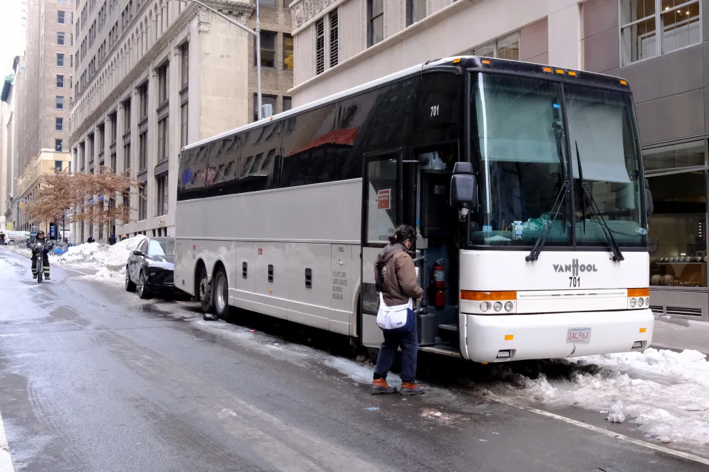 A white bus labeled 
