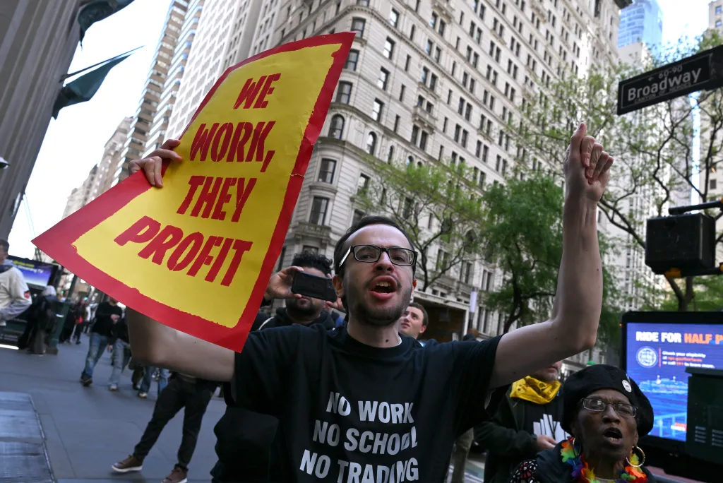 A protester waves a sign at the protest.