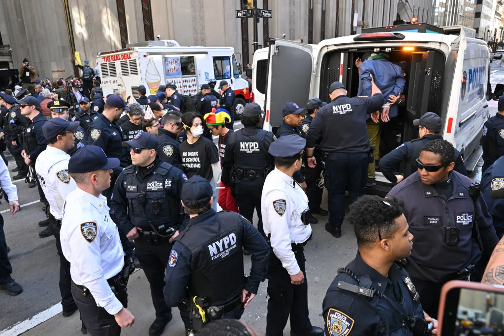 Police arrest protesters.