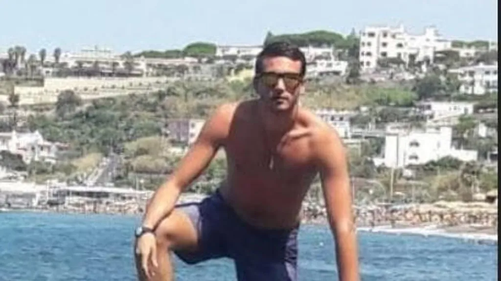 Federico Gualtieri posing in a swimsuit and sunglasses for a photo.