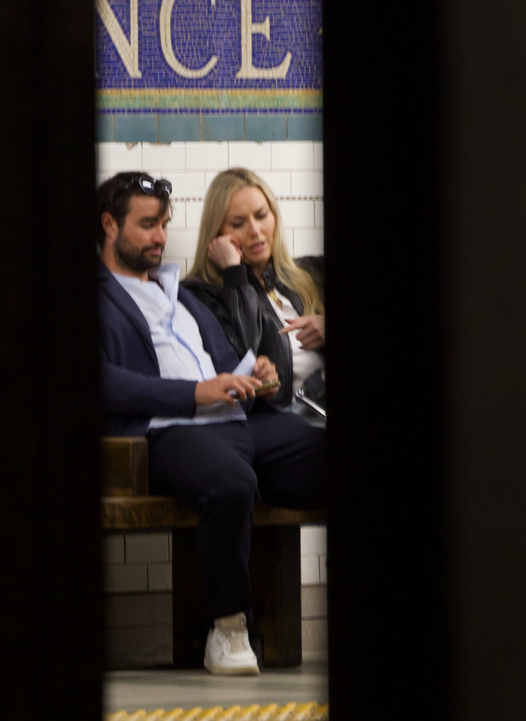 Lindsey Vonn and Matthieu Bailet sitting together in a subway station.