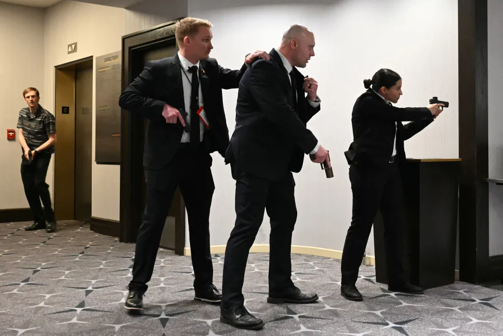 Secret Service agents drawing their guns during an incident at the White House Correspondents' dinner.