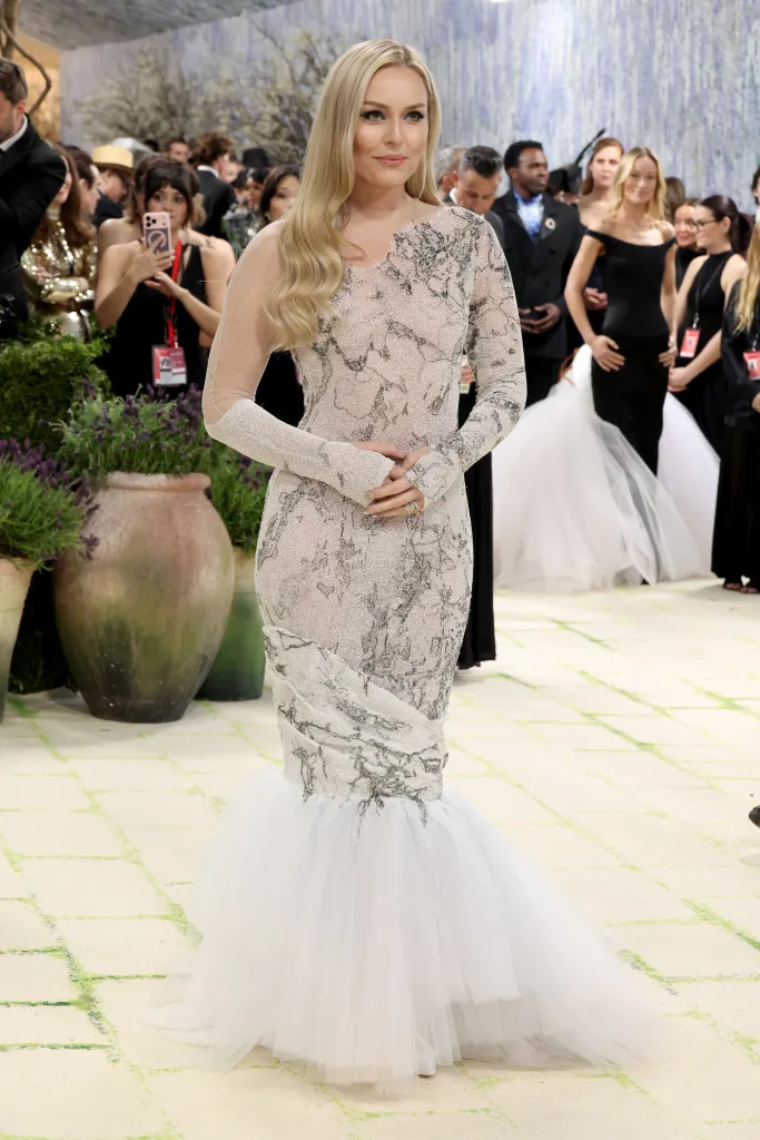 Lindsey Vonn in a long-sleeved, fitted, white and silver gown with a full white tulle skirt.