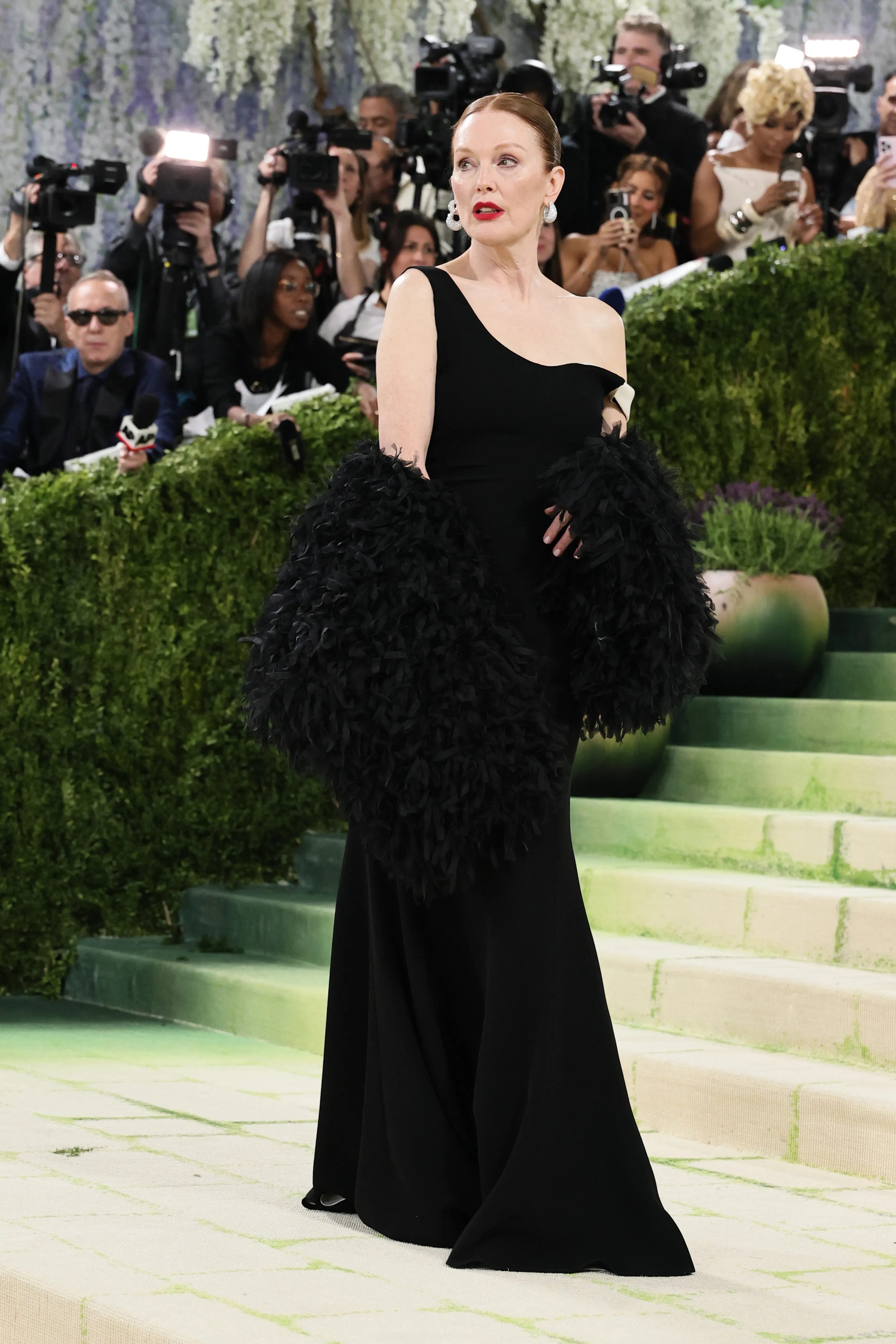 Julianne Moore in a black gown with dramatic ruffled sleeves at the 2026 Met Gala.