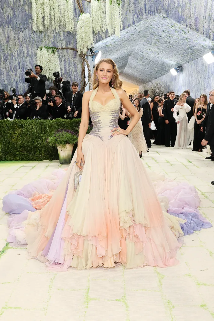 Blake Lively in a pastel ombre gown with a long, ruffled train at the Met Gala.