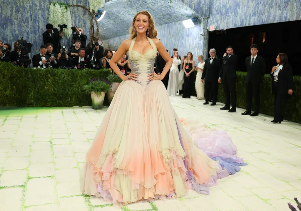 Blake Lively in a pastel ombre gown with a long train at the Met Gala.