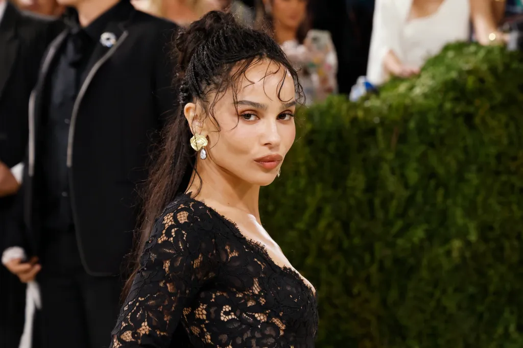 Zoe Kravitz in a black lace dress and gold earrings.