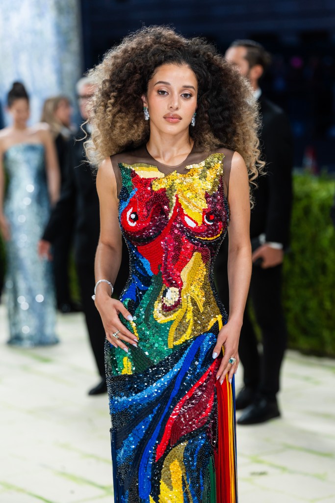 Chase Infiniti attends the Met Gala in a colorful sequined gown featuring abstract shapes.