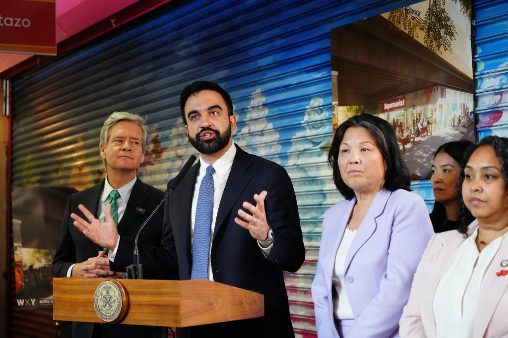 Mayor Mamadani standing with city officials in front La Marqueta.