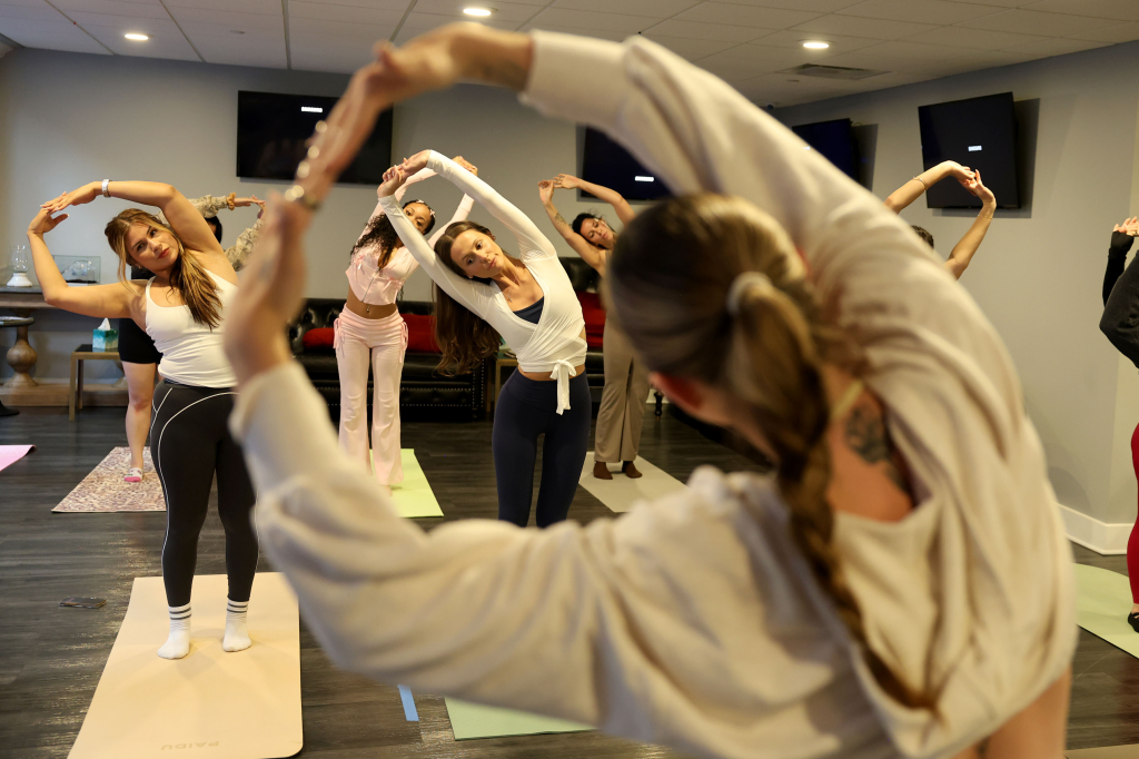 Georgia Worrell and other women participate in a Pilates class.