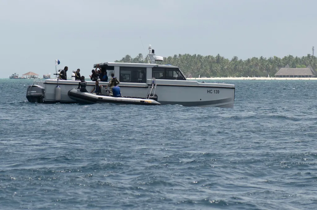 Members of the Maldives National Defence Force on a boat during a search and recovery operation.