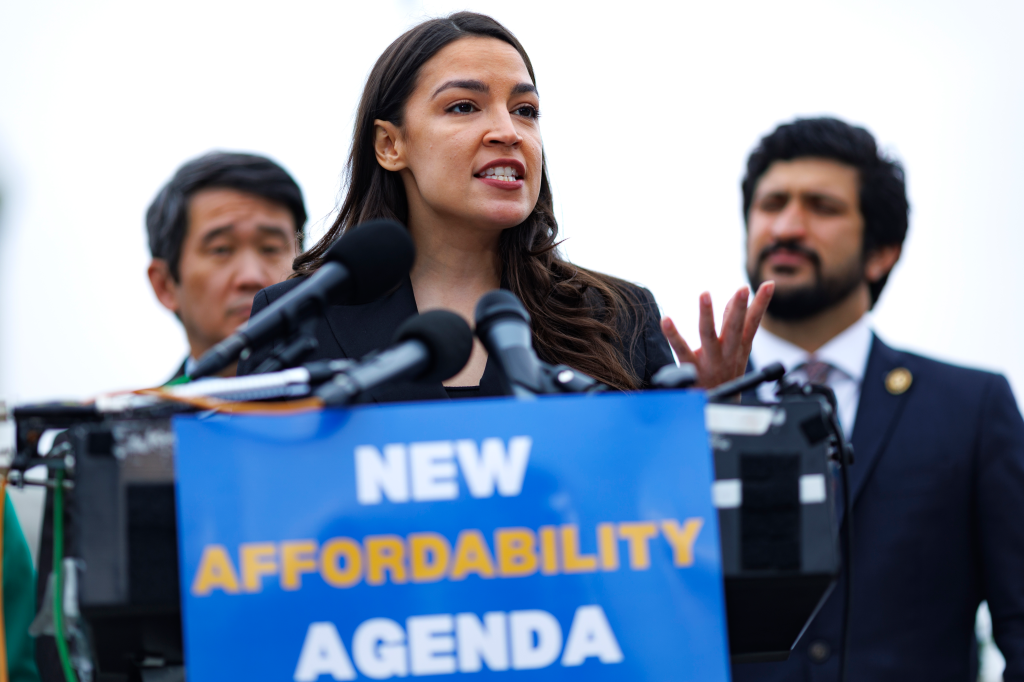 Rep. Alexandria Ocasio-Cortez speaking at a news conference about the new affordability agenda, with a sign reading 