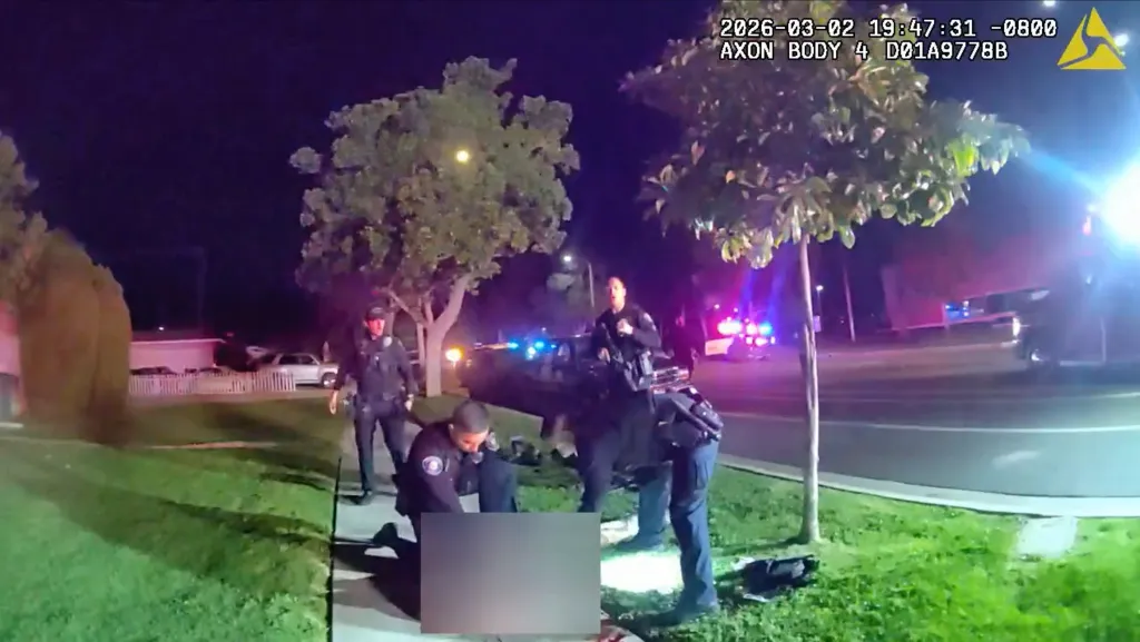 Police officers at a crime scene at night.